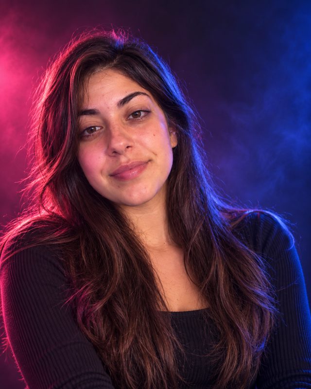 Example of the Color-gel studio look: a woman with long dark hair lit by pink and blue colored lights