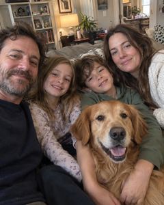Example phone photo: a selfie of a family of four and their golden retriever on the sofa