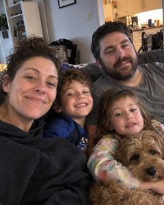 Example phone photo: a selfie of a family of four and their dog on the sofa