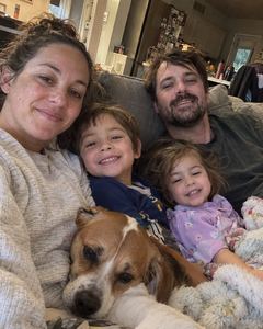 Example phone photo: a selfie of a family of four and their dog on the sofa