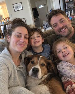 Example phone photo: a selfie of a family of four and their dog at home