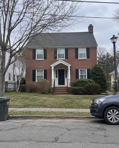Example phone photo: a red-brick house with black shutters on an overcast day