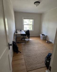 Example phone photo: a bare spare room with a small desk and a laundry basket