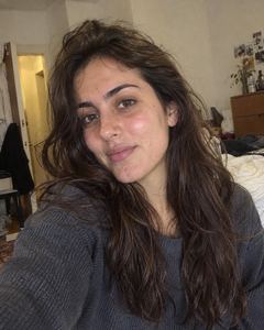 Example phone photo: a selfie of a woman with long dark hair in her bedroom