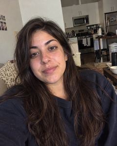 Example phone photo: a selfie of a woman with long dark hair at home