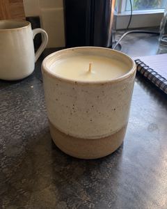 Example phone photo: a stoneware candle on a dark kitchen counter beside a mug